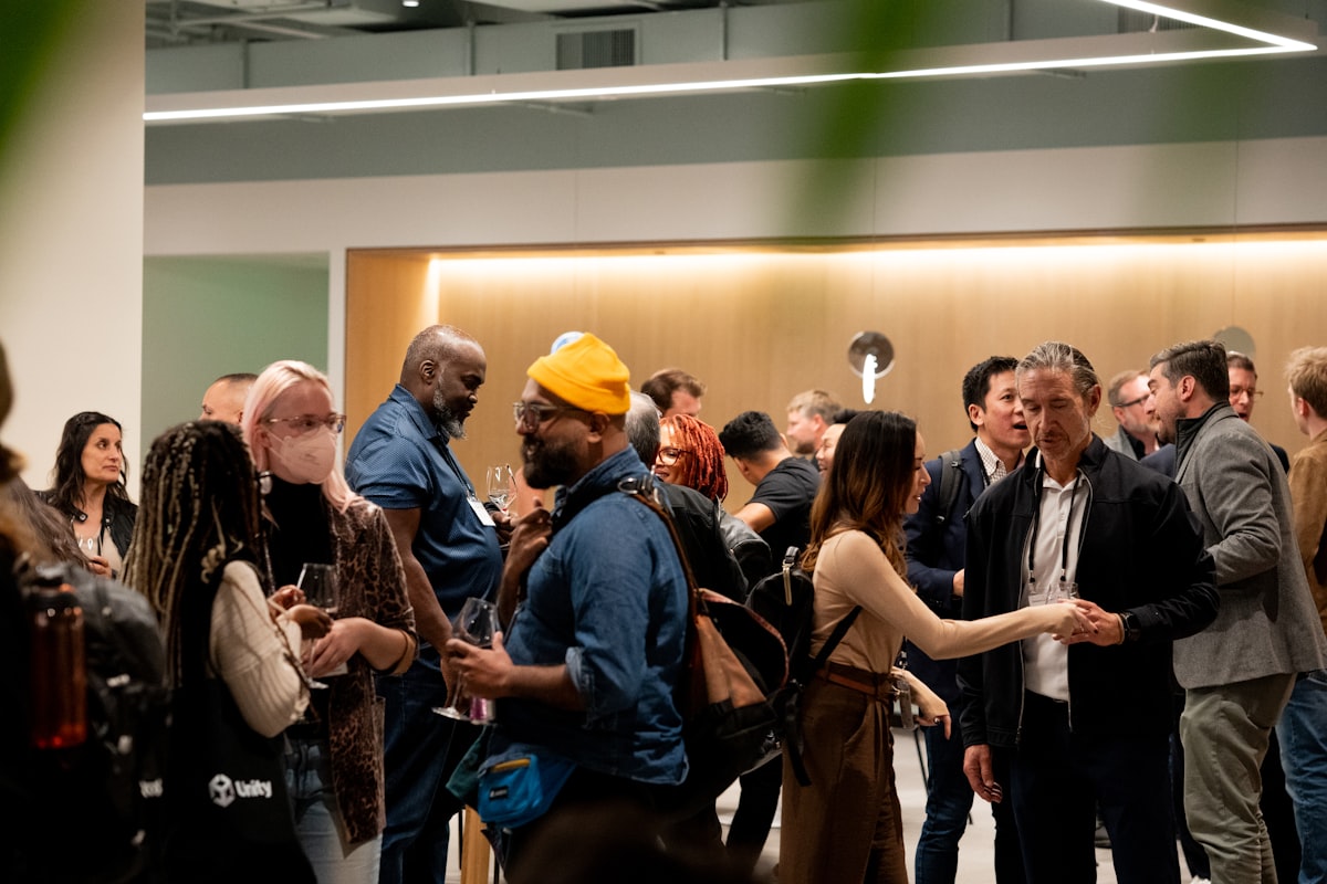 Team members mingling and connecting at a warmly lit event